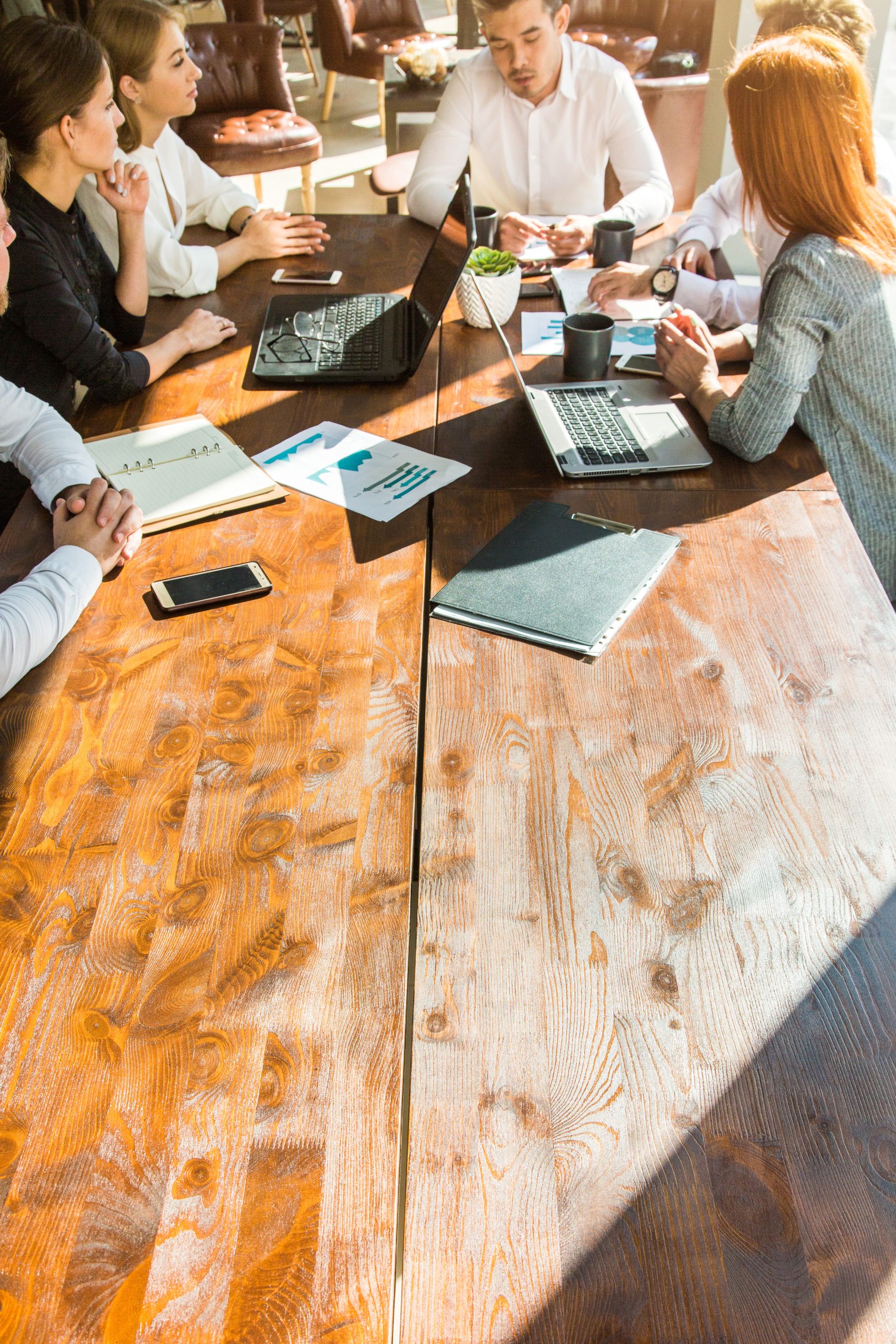 A team of young businessmen working and communicating together in an office. Corporate businessteam and manager in a meeting